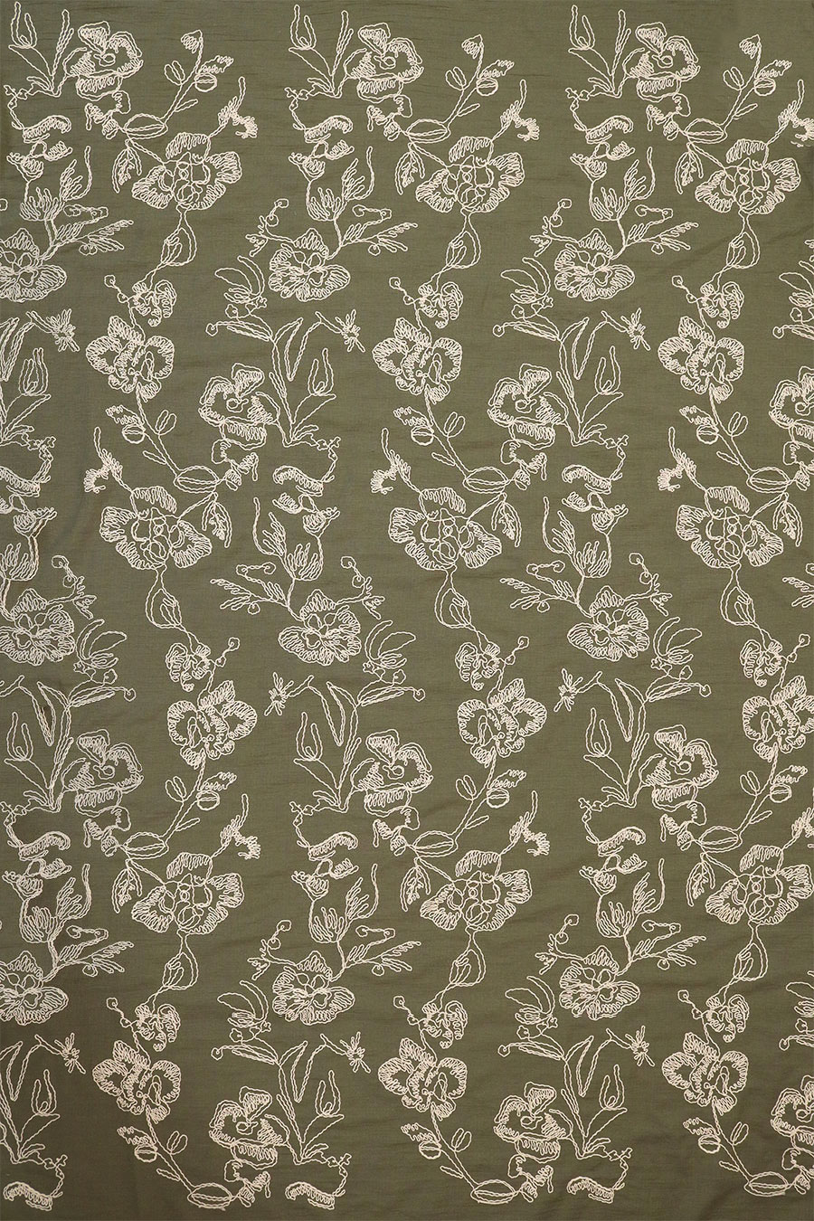 Full-width view and overall pattern repeat of the white cording embroidered fabric on green background